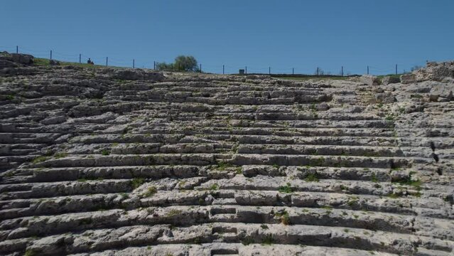 Roman amfitheater ancient architecture fly through wall FPV aerial drone shots, sunny historical site.