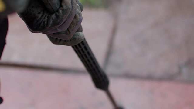 Close up shot of a water pressure cleaner cleaning flagstones. Looking down onto the cleaning process. Flagstone getting clean.
