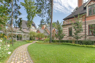 Fototapeta premium view of the sheared lawn with a path near the house