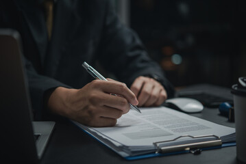 Hand Signing a Contract with Pen. business, finance, or legal projects, formal agreements and partnerships.