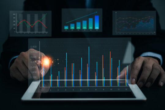 Business analysis big data screen and economic growth with financial graph. digital tablet marketing plan, Investment concept of virtual dashboard technology visualization.
