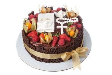 Decorative colorful cake decorated with fruits for baby's christening with bible and cross. On a white isolated background.
