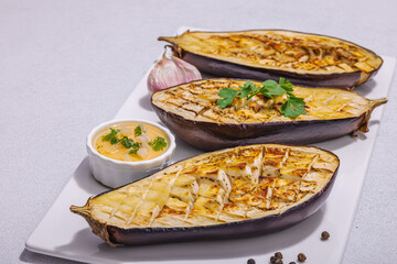 Grilled eggplants with olive oil, garlic and greens. Traditional food for picnic or barbecue