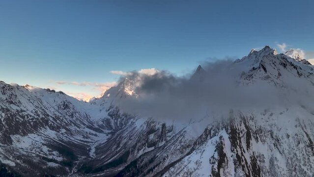 Panorama of the Caucasian mountains sky-high peaks and sunset light. North Caucasus village Dombay. Panorama of the gorges