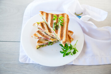 fried toasts stuffed with sausage, cheese and greens inside, in a bowl .