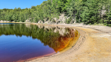 Red, yellow and blue, colorful waters of the Afryka lake in the Muskau Bend, the remins of the minining activity at the area.  © TOMASZ