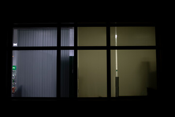 Window in building at night. Window in house. Light from office.