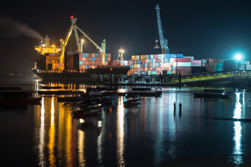Fototapeta na wymiar Night view / skyline of the Port of Zanzibar with container ships and a public fishing beach in the foreground _Tanzania, Africa