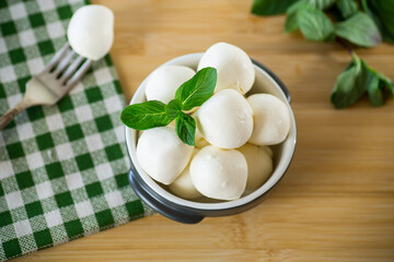 Small balls of traditional mozzarella in a ceramic bowl