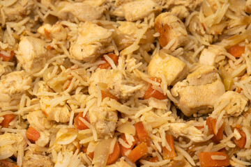 Tasty pilaf with chicken as background.