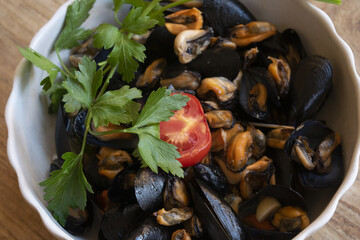 mussel soup with parsley and tomato
