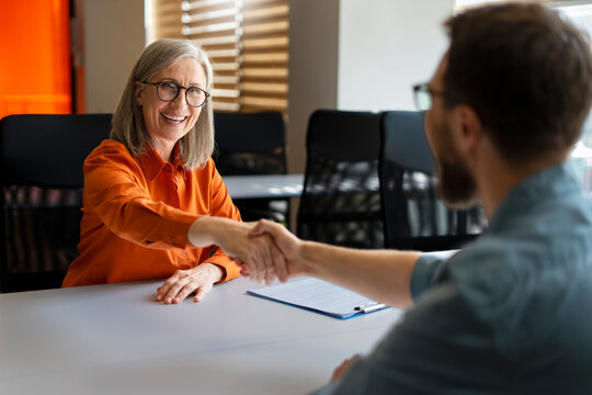 Group Of Smiling Business People Hand Shaking Working Together In Modern Office. Meeting, Teamwork, Successful Business. Job Interview Concept