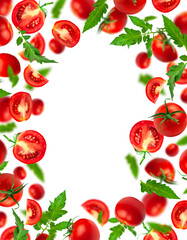 Flying cut out red ripe juicy tomatoes and green leaves isolated on white background. With clipping...