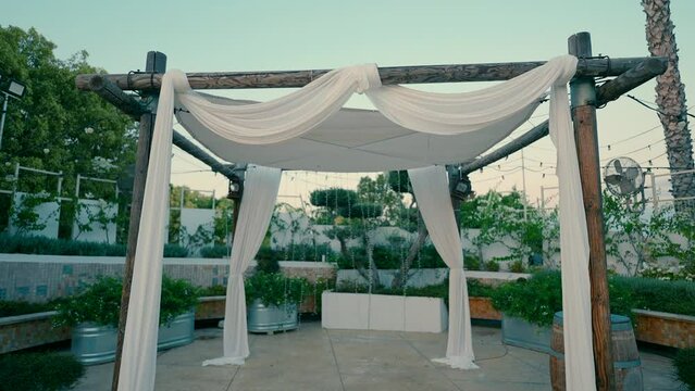 A canopy stands under the sky in an event garden in the evening. High quality FullHD footage