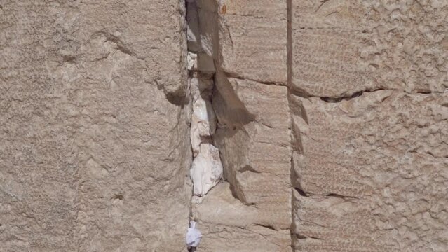 Prayer Notes To God Are Tuck it into a Crevice At The Western Wall Of Jerusalem In Israel - close up