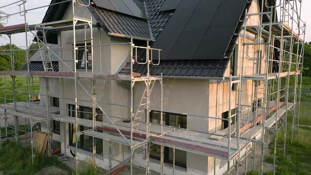 Crane shot of a single family house with solar panels under construction