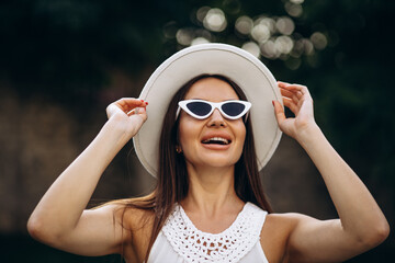 Portrait of beautiful woman in a summer hat
