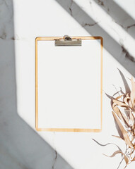 Clipboard with blank paper with copy space on white background with shadows