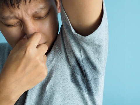 Asian man with wet armpits Smelly odor from sweat Lack of self-confidence, anxiety, problems from hot weather
