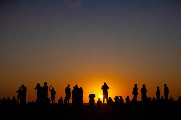 Fototapeta na wymiar Silhouette of people at sunset