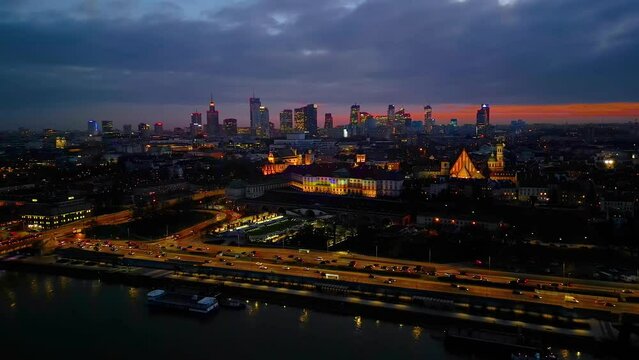 Night Warsaw's Old Town viewed from the royal castle at a height. Beautiful architecture and city lights in Poland. Modern downtown financial center view after sunset, dusk cityscape, skyline. Aerial