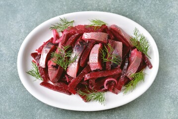 Salad with boiled beets, salted herring and onions