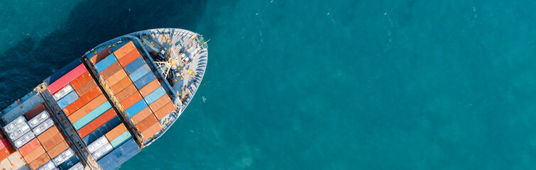 Top-down aerial view of a large container cargo ship moving over the open ocean with copy space. Logistics and transportation. Banner background - obrazy, fototapety, plakaty