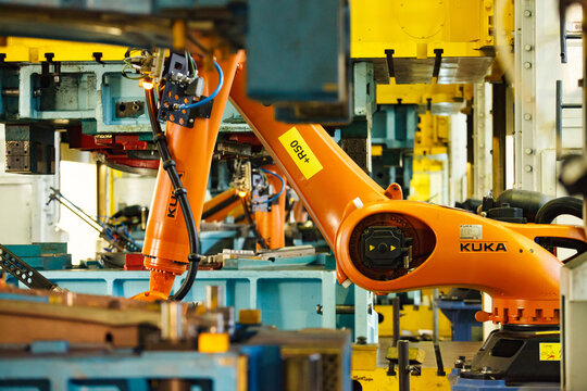 Nizhny Novgorod, Russia - November 21, 2020: GAZ car production plant. Kuka robot manipulator and stamping press.