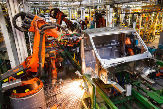 Nizhny Novgorod, Russia - November 21, 2020: GAZ car production plant. Auto bodies automatic welding line. Kuka robot manipulators, welding sparks