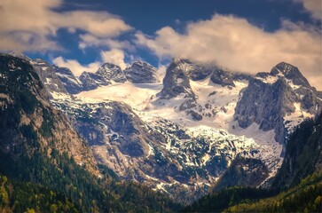 Mountain landscape in Austria in spring season. View of Hoher Dachstein from the lake Vorderer Gosausee in Austrian Alps.