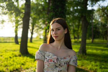 Fototapeta premium Beautiful Young Happy Woman Enjoying the Sunlight in a Public Park