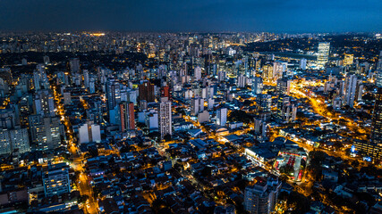 view from above the city of São Paulo at night, city lights, buildings and houses lit, Brazil