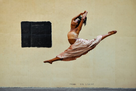 modern ballerina female dancer jumping split in the air