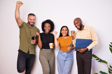 Diverse creative tech team lean against wall and celebrates success, cheer smile