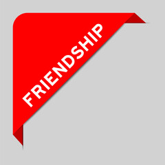 Red color of corner label banner with word friendship on gray background