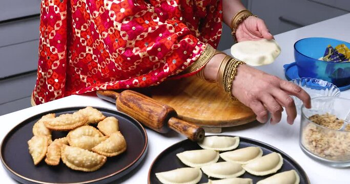 Gujiya is a classic north Indian sweet of crisp flaky pastry filled with khoya ( Milk solids ) and nuts stuffing, generally fried. This traditional sweet is enjoyed during Holi and Diwali festivals.