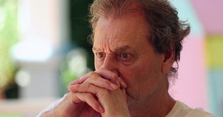 Pensive older man thinking deeply. Candid thoughtful senior person pondering decision