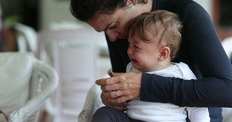 Parent cutitng and trimming baby infant son hand nails