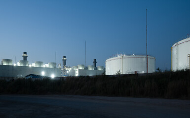 Big coal power plant with pipes and smokestacks white at dusk