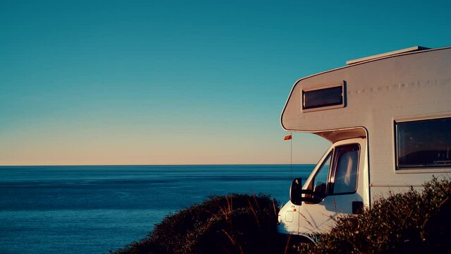 Camper rv camping on coast sea shore at sunny day. Holidays in Spain in wintertime, travel with motor home.