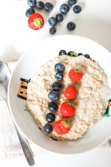 Oatmeal with berries top view. Porridge for breakfast for a child. Proper nutrition