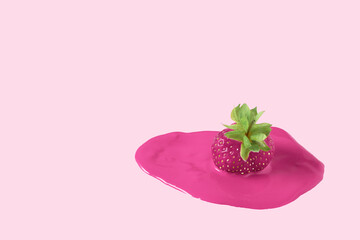 Ripe pink strawberries with melted pink color. Cooking  dessert on a pink background.