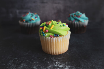 On a textured dark background, cakes.Celebration