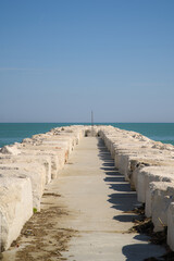 A breakwater in the sea on a clear, warm, sunny day