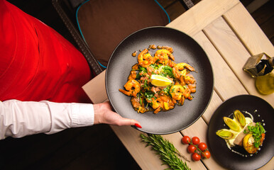 Prawns served by the waitress in restaurant.