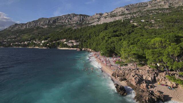 Aerial panoramic drone view of Podrace Beach in Brela, Kamen Brela, symbol of Brela, Punta Rata, Makarska Riviera