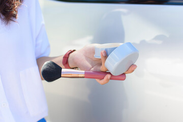 Cosmetics in the hands of a makeup artist.