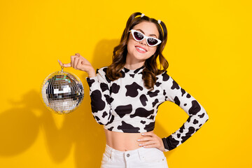 Photo of lovely clubber girl in spotted shirt hold disco ball having fun isolated shine color...