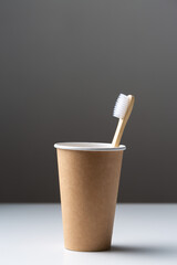 Toothbrush in a cardboard ecological cardboard cup, hygiene health care.