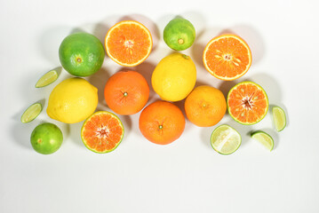 Close up view of juicy organic citrus fruit whole and halved visible core isolated white background copy space Vitamin C packed food concept. flat top view